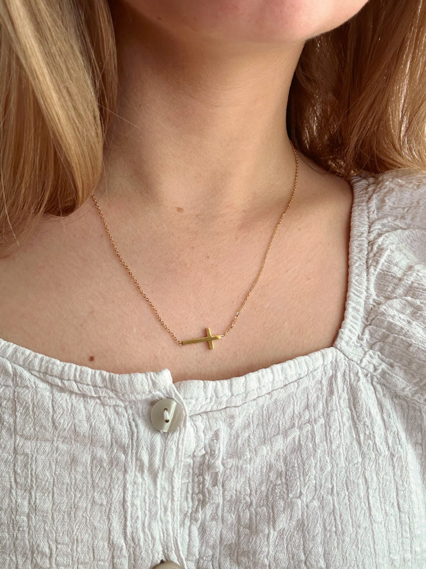sideway cross necklace, on neck image, gold