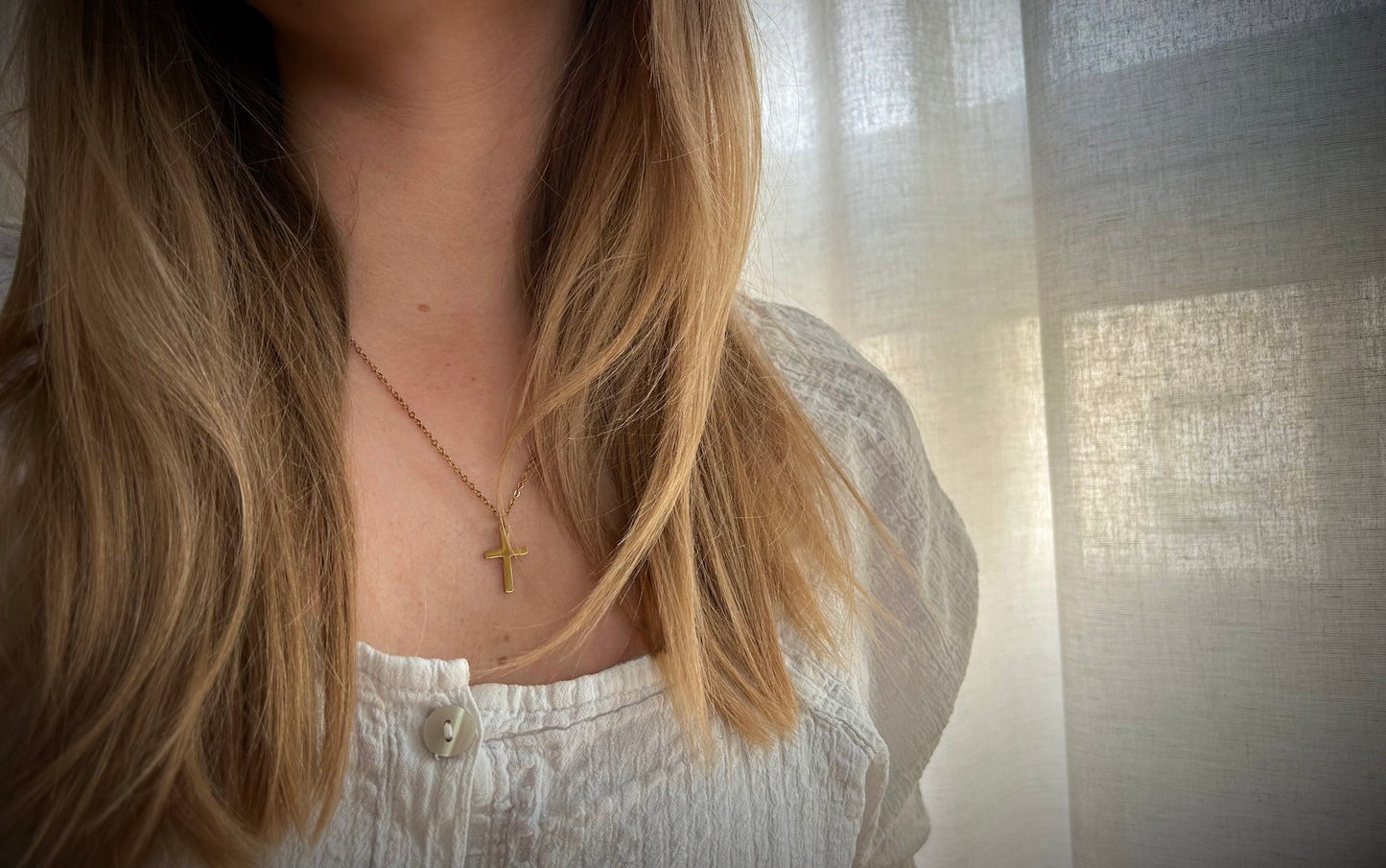 gold cross neckace, hannah necklace, gold chain, on neck image